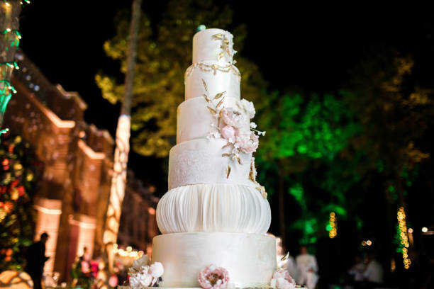 istock Multilevel wedding cake decorated with pink flowers 1411261916