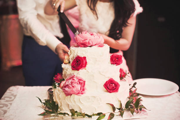 istock Multilevel wedding cake decorated with pink flowers 1411261962