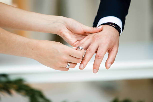 istock Bride and groom exchange rings at the wedding ceremony 1411262845