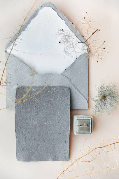 istock Wedding rings in a box and vintage invitations on the table 1411262935