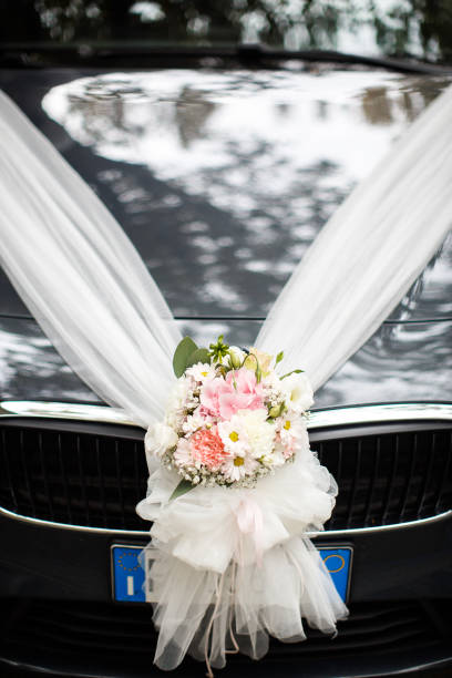 istock Wedding car decorated with a bright bouquet and ribbons 1411262939