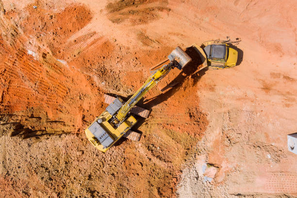 istock An excavation work is being carried out on a construction site using an excavator for dumping earth for loading into a dump truck 1411263013