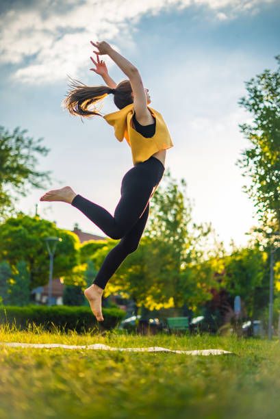 istock Young woman flexing exercises, outdoor yoga 1411263621