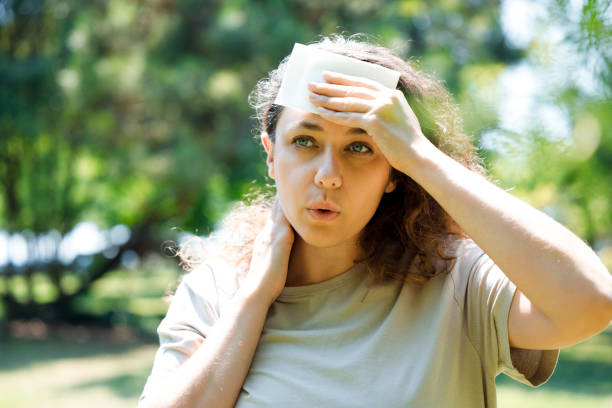 istock Young woman having hot flash and sweating in a warm summer day 1411266548