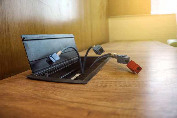 istock Female LAN connectors on the wooden table. LAN cables on the table. 1411268057