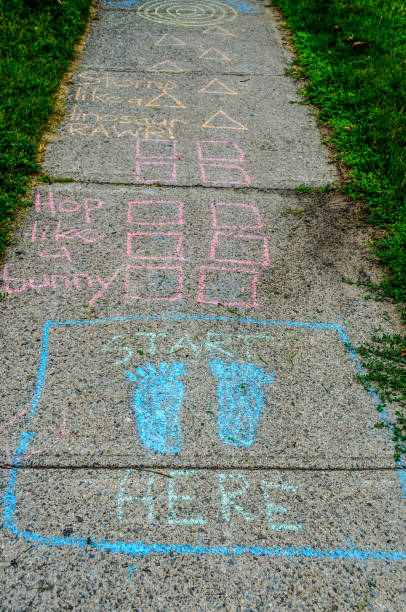Child's hopscotch game drawn in chalk on a sidewalk on a summer day