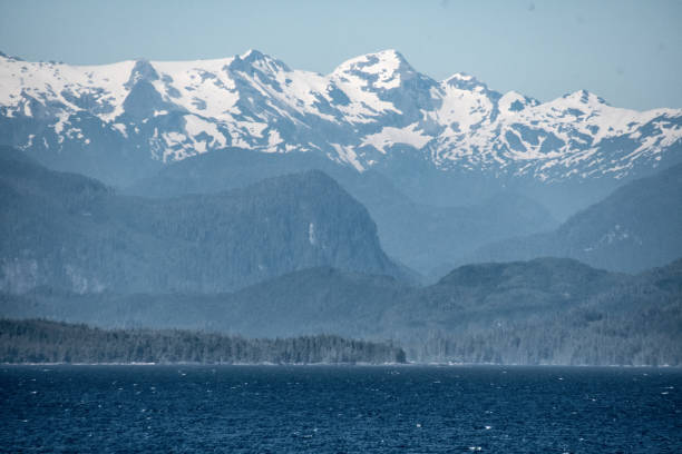 istock Snowcapped mountain range with bay in foreground 1411270012