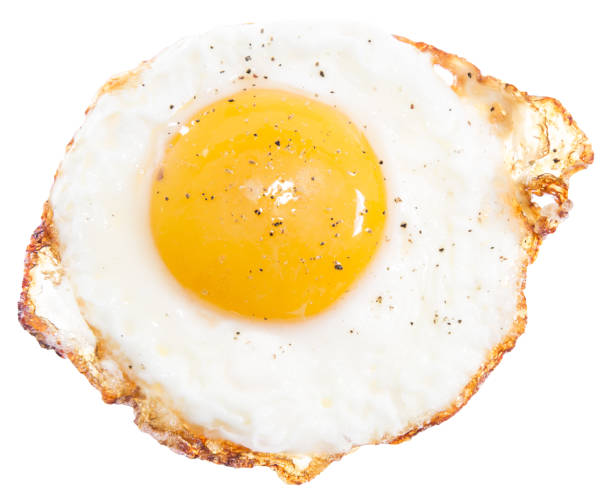 Sunny side top up egg isolated on plain white background top egg view stock photo