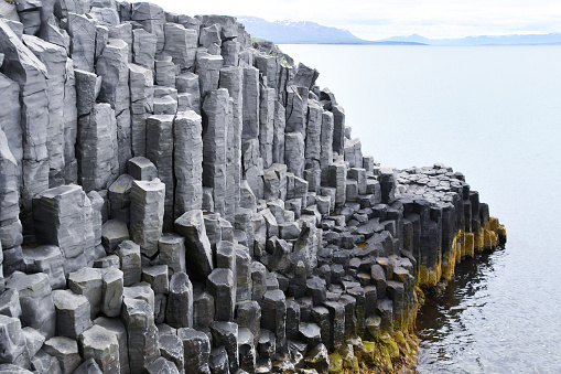 Tall and gray basalt columns - northern coast of Iceland in Europe