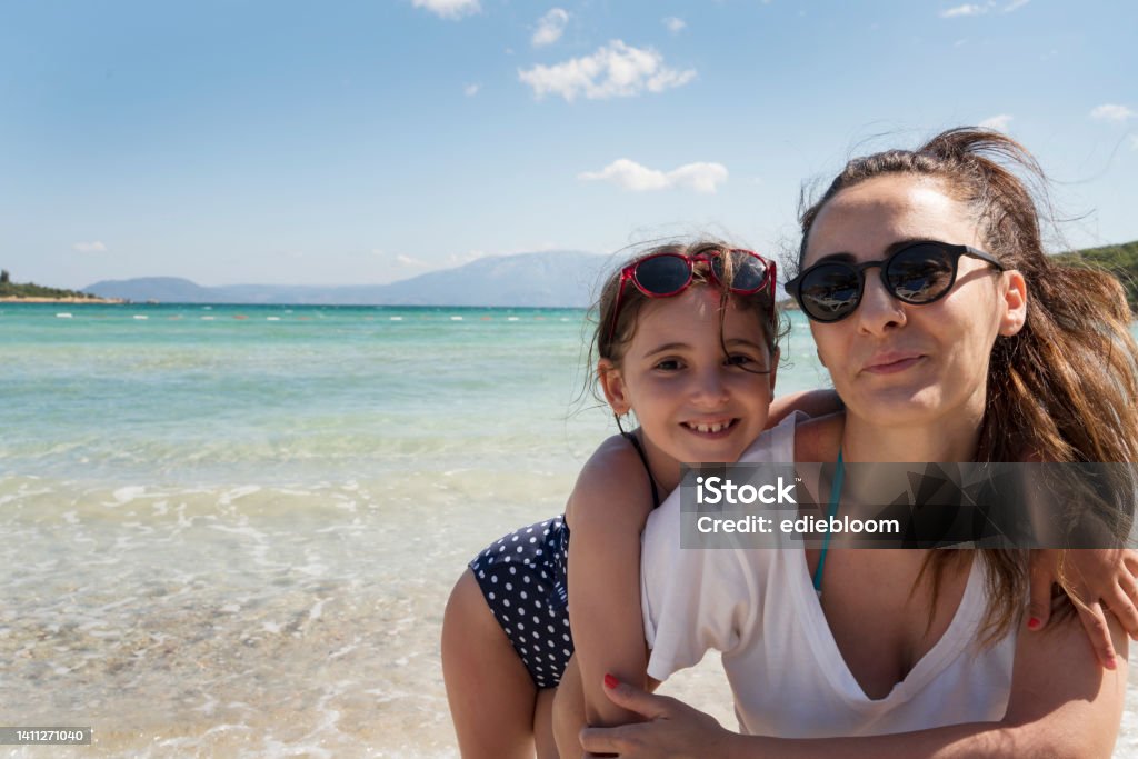 Mother with daughter at beach Adult Stock Photo