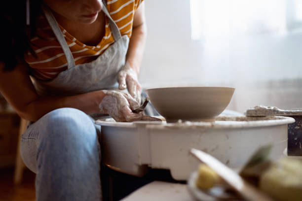 istock Unrecognizable female potter, working on pottery wheel 1411271363