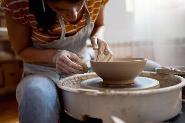 istock Unrecognizable female potter, working on pottery wheel 1411271369