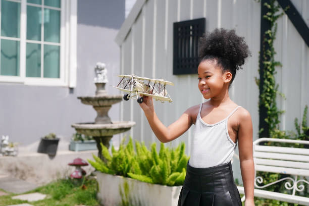 istock Young girl playing with toy airplane 1411271506