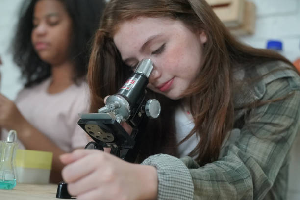 istock Student in classroom, young girl happy funny study and play with experimenting in class. 1411272342