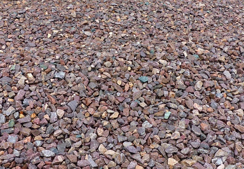 Train watching spot in Rochelle, Illinois outside of Chicago. Rocks and gravel on railroad tracks. Multicolored, bright rocks of different sizes. Can be used for background.