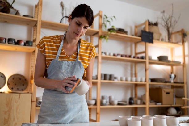 istock Female potter, using sandpaper to polish the pottery 1411272661