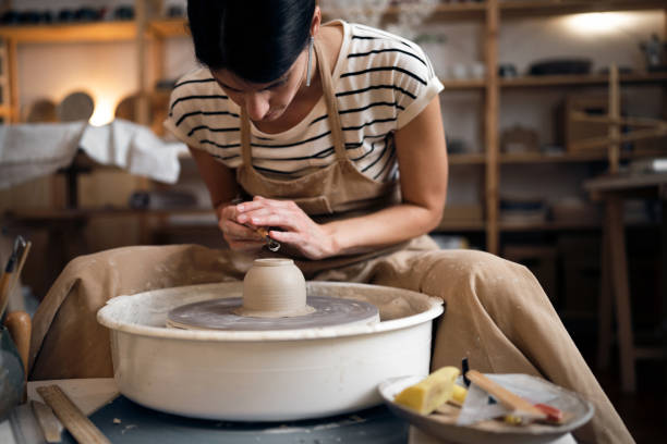 istock Woman making pottery in her art studio 1411272667