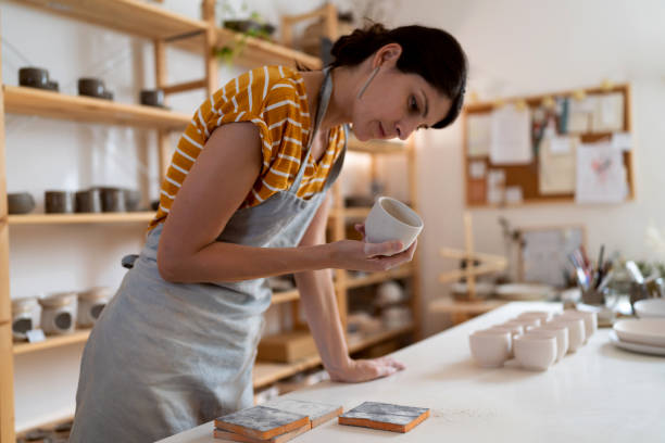 istock Female potter, using sandpaper to polish the pottery 1411272699
