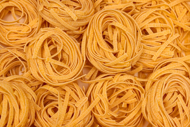 Raw wheat pasta pile stock photo