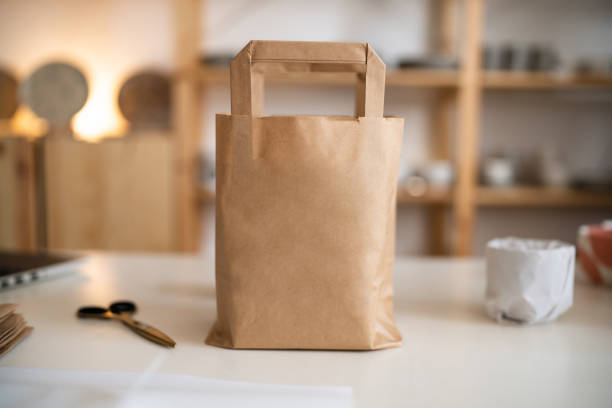 istock Pottery package in the brown paper bag on the desk 1411273025