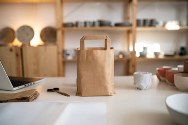 istock Pottery package in the brown paper bag on the desk 1411273034
