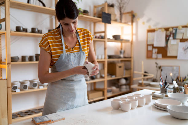 istock Female potter, using sandpaper to polish the pottery 1411273091