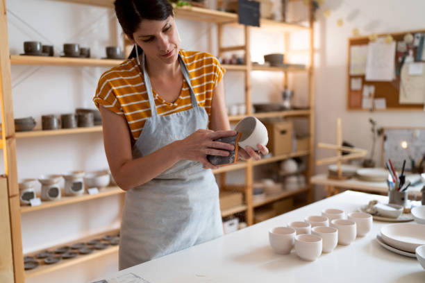istock Female potter, using sandpaper to polish the pottery 1411273094