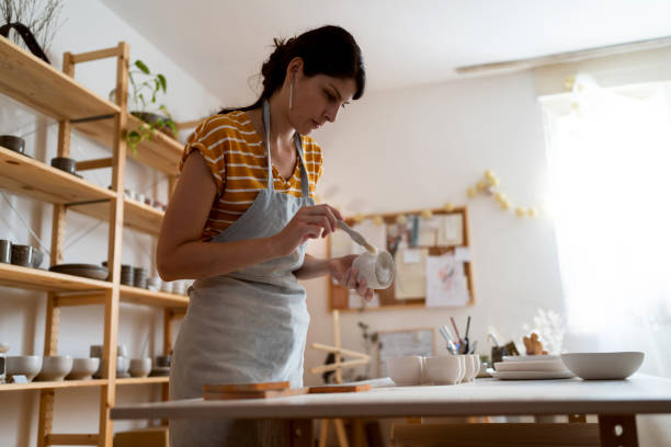 istock Female potter, using sandpaper to polish the pottery 1411273748