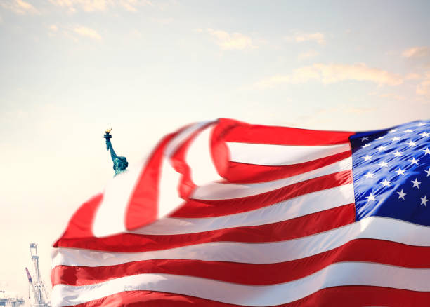 istock Statue of Liberty and American flag 1411273887