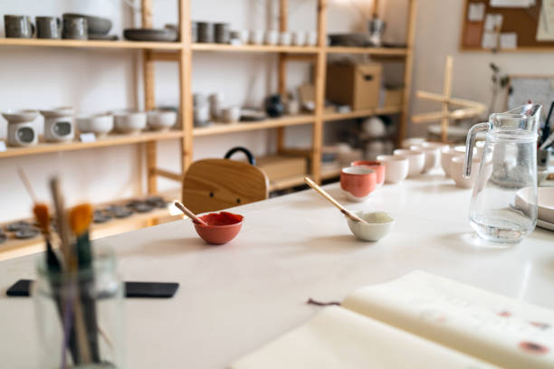 istock Pottery bowls, with paint and paintbrush 1411274045