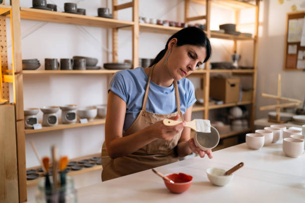 istock Caucasian female potter working in her art studio 1411274535