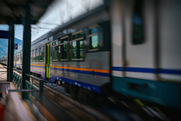 Train arrives at regular rural train station in Italy.