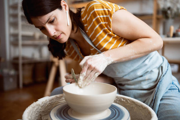 istock Caucasian female potter, working on pottery wheel 1411274682