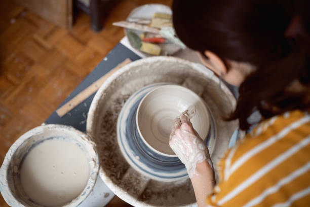 istock Unrecognizable female potter, working on pottery wheel 1411274683