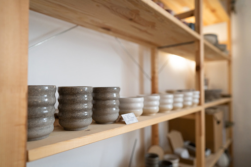 Shelf with ceramics in pottery workshop.