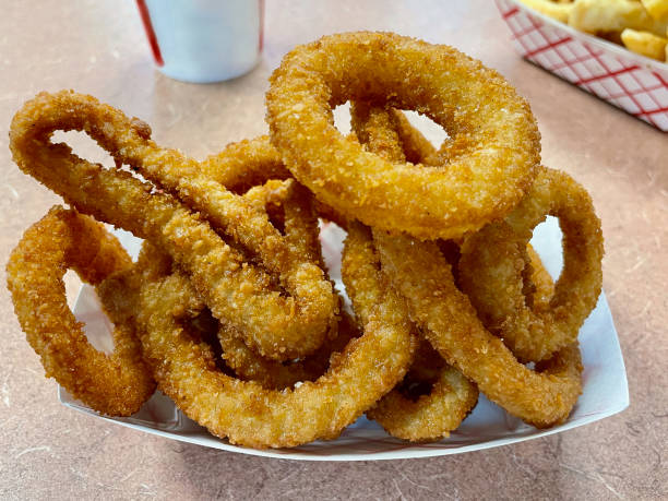 Fried onion rings with mozzarella or plain. Delicious onion rings on white background