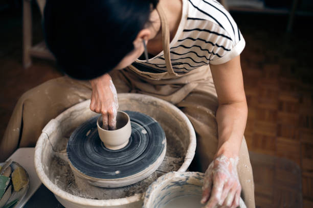 istock Woman working with a pottery wheel in her workshop 1411275662