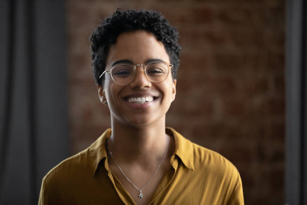 istock African woman in glasses having charming smile pose for camera 1411275791