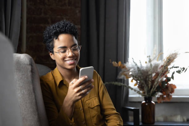 istock African woman rest on armchair using smartphone 1411275966
