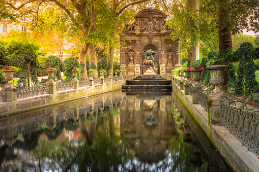 Peaceful Medici fountain pond in Luxembourg gardens, Paris, France, long exposure