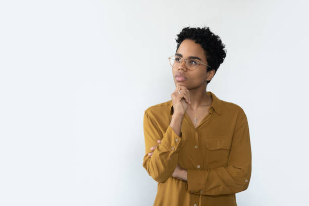 istock Thoughtful African woman staring aside at copy space, studio shot 1411276571
