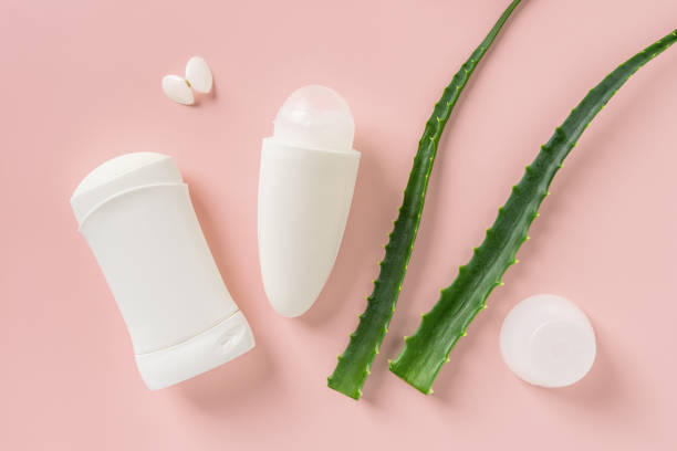 istock Roll on antiperspirant, solid deodorant and two fresh green aloe leaves over pastel coral background. Natural toiletries for body care. Organic cosmetics for personal hygiene. 1411276581