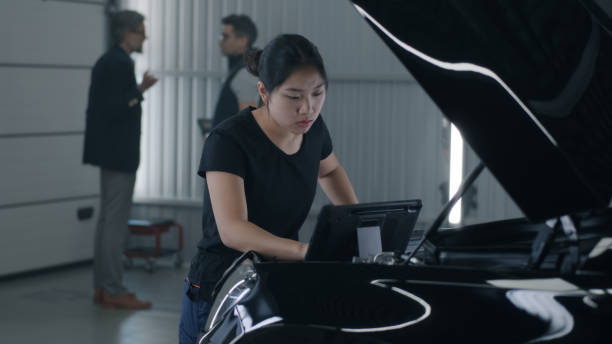 istock Female mechanic inspecting car engine 1411276840