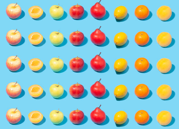 istock Ripe yellow apricots, apples, lemons and pears on light blue background 1411277134