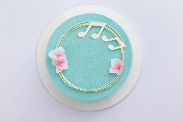 istock Chocolate mousse cake on a white background top view. Cake for a musician's birthday. 1411277194