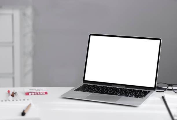 istock Laptop on white table with white blank screen and copy space. 1411278336