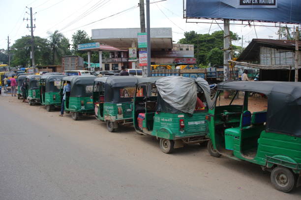 A CNG (Compressed Natural Gas) filling station A long line of CNG-powered auto rickshaws to get gas in front of a CNG (compressed natural gas) filling station at Sylhet in Bangladesh on 27 June 27, 2022. sylhet stock pictures, royalty-free photos & images