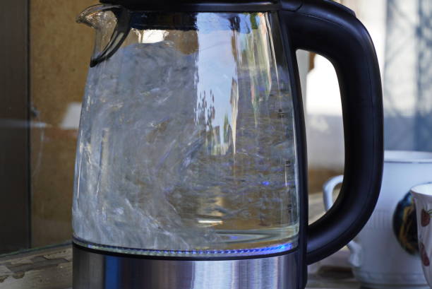 istock a glass kettle with boiling water on a table 1411279904