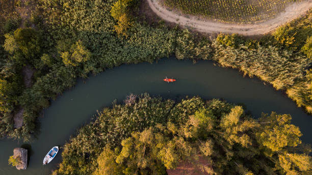 istock Drone footage of rowing canoe on river 1411282769