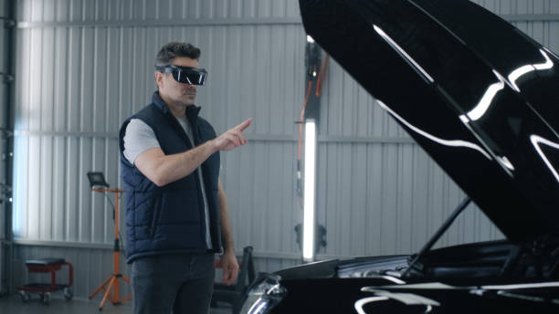 istock Mechanic in VR glasses diagnosing a car 1411283556